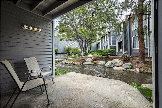 25301 Pine Creek Ln, Wilmington, CA 90744 - view of patio featuring a small pond
