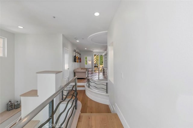 7 Suprema Dr, Newport Coast, CA 92657 - hallway with an upstairs landing, light wood-type flooring, recessed lighting, and baseboards