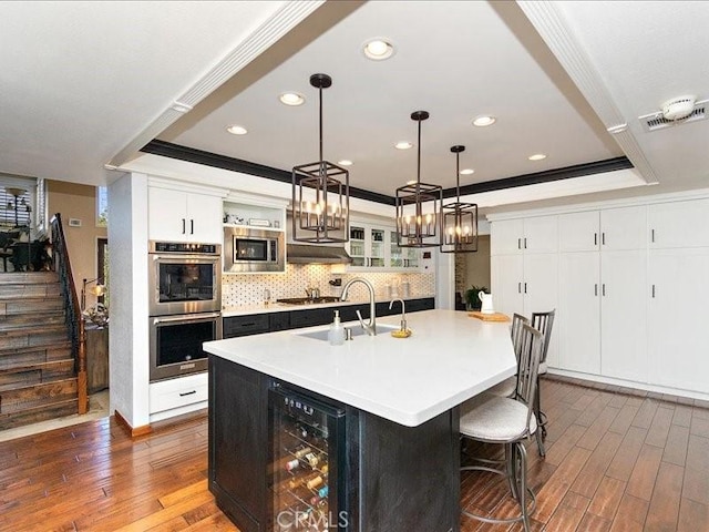 2565 Cliff Rd, Upland, CA 91784 - kitchen featuring a sink, wine cooler, dark wood finished floors, a tray ceiling, and appliances with stainless steel finishes