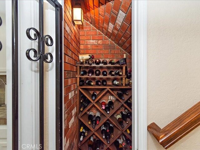 2565 Cliff Rd, Upland, CA 91784 - wine area featuring a textured wall and vaulted ceiling