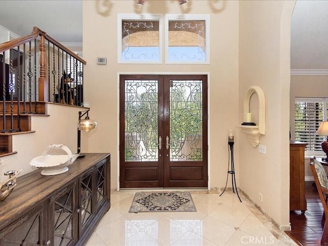 2565 Cliff Rd, Upland, CA 91784 - tiled entryway with french doors, baseboards, crown molding, a towering ceiling, and arched walkways