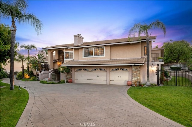 2565 Cliff Rd, Upland, CA 91784 - view of front of house featuring decorative driveway, stucco siding, a garage, and a chimney