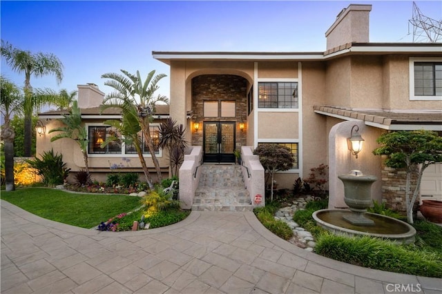 2565 Cliff Rd, Upland, CA 91784 - view of front of property featuring french doors, stucco siding, and a chimney