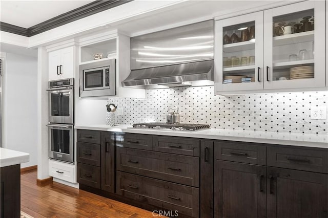 2565 Cliff Rd, Upland, CA 91784 - kitchen with stainless steel appliances, wall chimney exhaust hood, backsplash, light countertops, and dark wood-type flooring