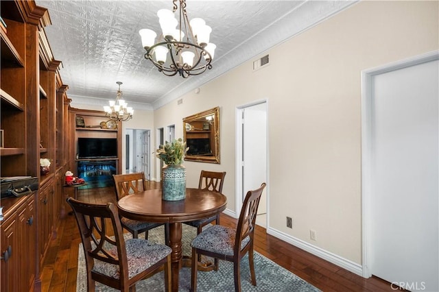 2565 Cliff Rd, Upland, CA 91784 - dining area with a chandelier, dark wood-style floors, an ornate ceiling, and ornamental molding