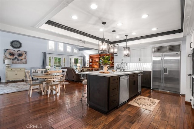 2565 Cliff Rd, Upland, CA 91784 - kitchen featuring stainless steel appliances, light countertops, crown molding, decorative backsplash, and a center island with sink