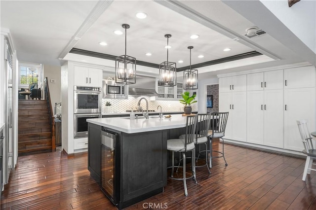 2565 Cliff Rd, Upland, CA 91784 - kitchen with a tray ceiling, stainless steel appliances, decorative backsplash, wine cooler, and recessed lighting