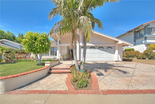 view of front of home with concrete driveway, a garage, stucco siding, and a front lawn
