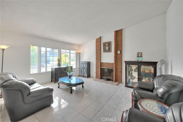 living area featuring light tile patterned flooring, a textured ceiling, and a fireplace