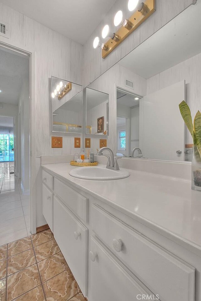 bathroom with tile patterned floors and vanity