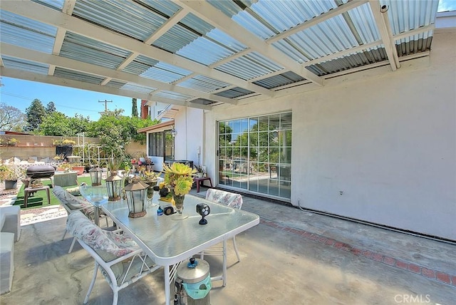 view of patio featuring fence and outdoor dining space