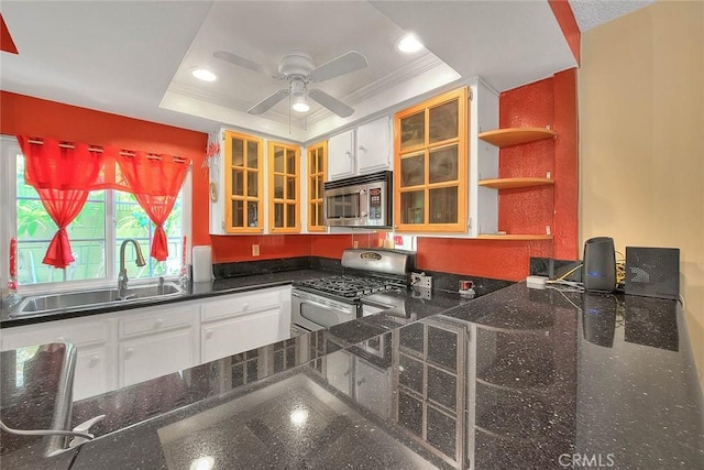 kitchen with stainless steel appliances, a sink, open shelves, a ceiling fan, and white cabinetry
