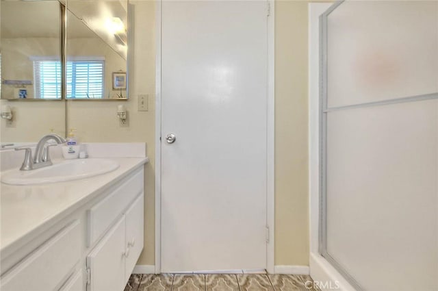 full bathroom featuring vanity and a shower with door