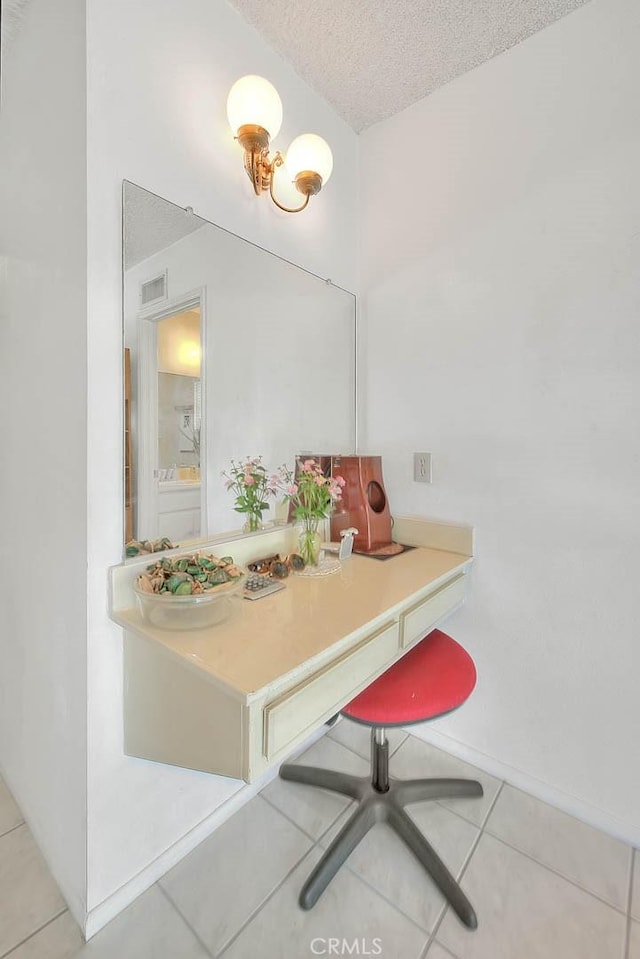 bathroom featuring tile patterned floors, a textured ceiling, and vanity