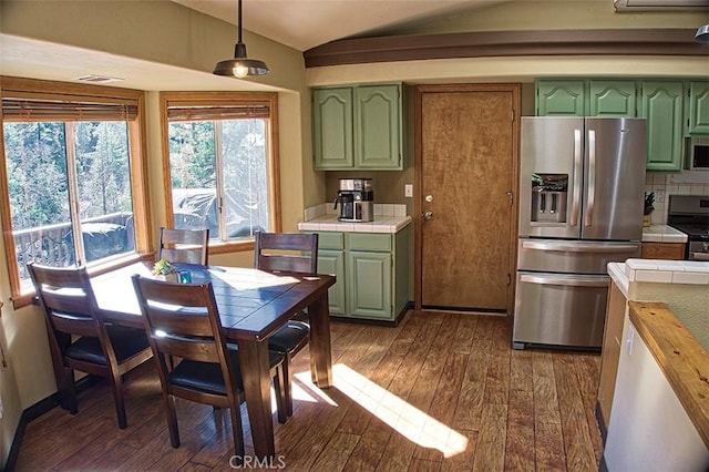 kitchen featuring tile countertops, stainless steel appliances, and green cabinetry