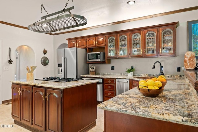 12617 Koenigstein Rd, Santa Paula, CA 93060 - kitchen featuring light stone countertops, stainless steel appliances, glass insert cabinets, a sink, and a center island