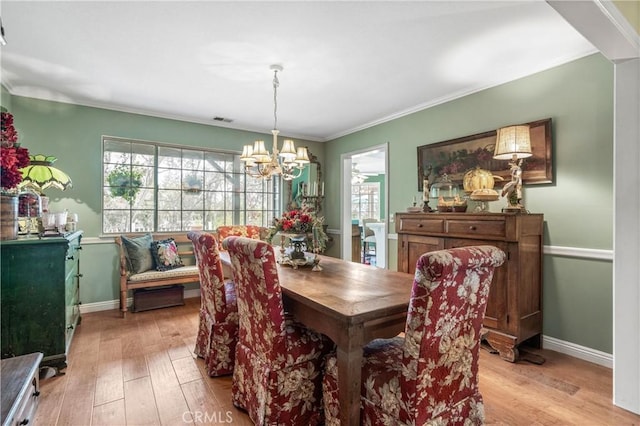 31065 Avenida Del Reposo, Temecula, CA 92591 - dining room featuring visible vents, baseboards, light wood finished floors, a notable chandelier, and ornamental molding