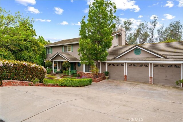 31065 Avenida Del Reposo, Temecula, CA 92591 - view of front of property featuring a garage, a chimney, and concrete driveway