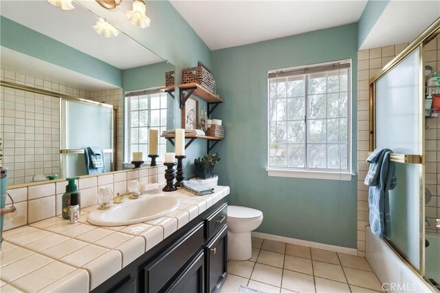 31065 Avenida Del Reposo, Temecula, CA 92591 - full bathroom featuring vanity, toilet, tile patterned floors, baseboards, and bath / shower combo with glass door