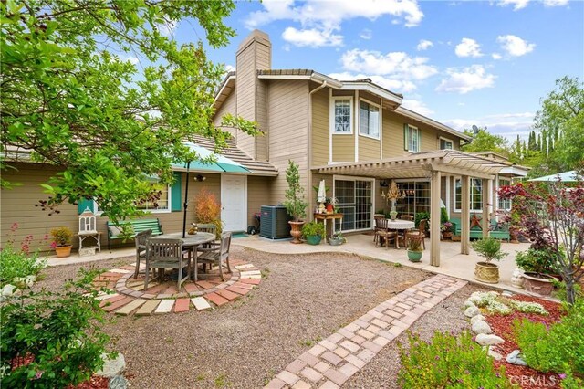 31065 Avenida Del Reposo, Temecula, CA 92591 - rear view of house featuring a pergola, outdoor dining area, a patio, and a chimney