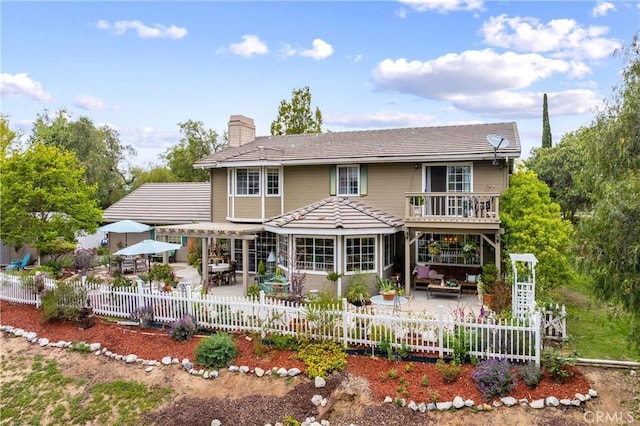 31065 Avenida Del Reposo, Temecula, CA 92591 - rear view of house featuring a fenced backyard, a chimney, a patio area, and outdoor lounge area