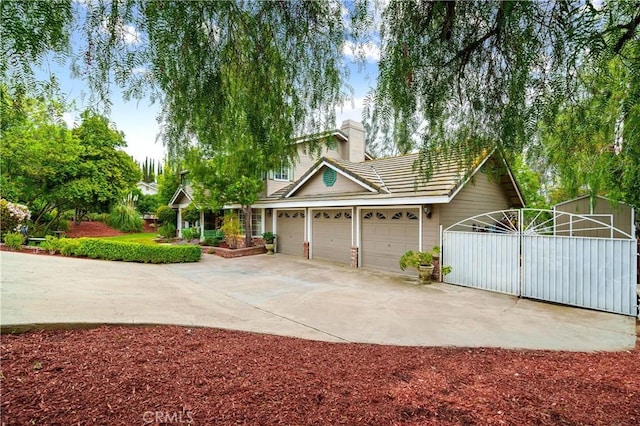 31065 Avenida Del Reposo, Temecula, CA 92591 - view of front of home with a chimney, a tile roof, a gate, a garage, and concrete driveway