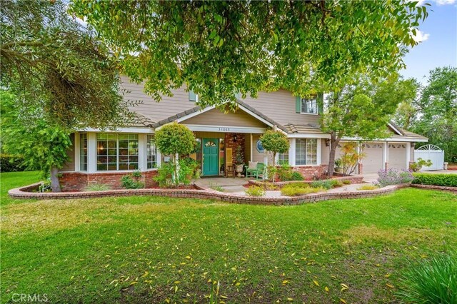 31065 Avenida Del Reposo, Temecula, CA 92591 - view of front of home featuring brick siding, an attached garage, and a front yard