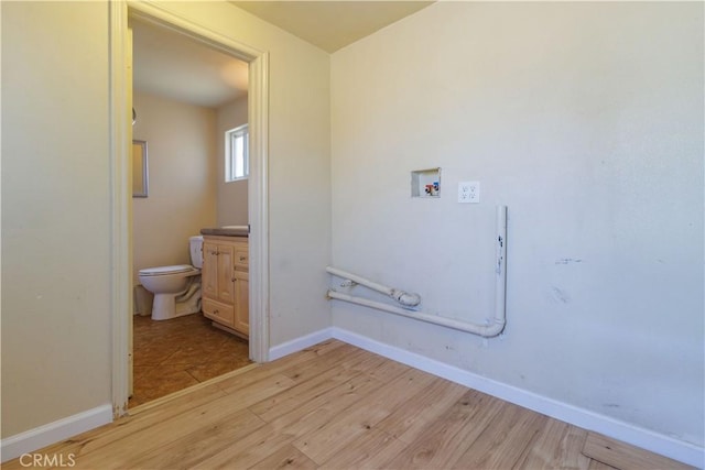 9408 Poplar Ave, Fontana, CA 92335 - washroom with light wood-style floors, hookup for a washing machine, and baseboards