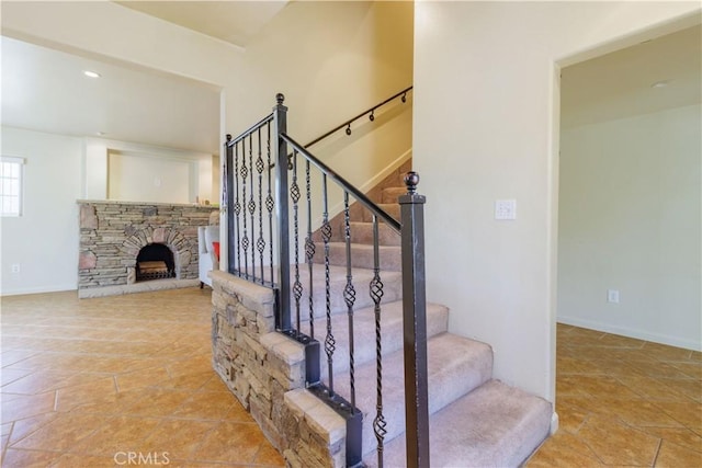 9408 Poplar Ave, Fontana, CA 92335 - stairs featuring a stone fireplace, baseboards, and recessed lighting