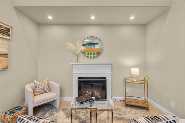 24912 Hearth Ct, Valencia, CA 91354 - living room with recessed lighting, a glass covered fireplace, wood finished floors, and baseboards