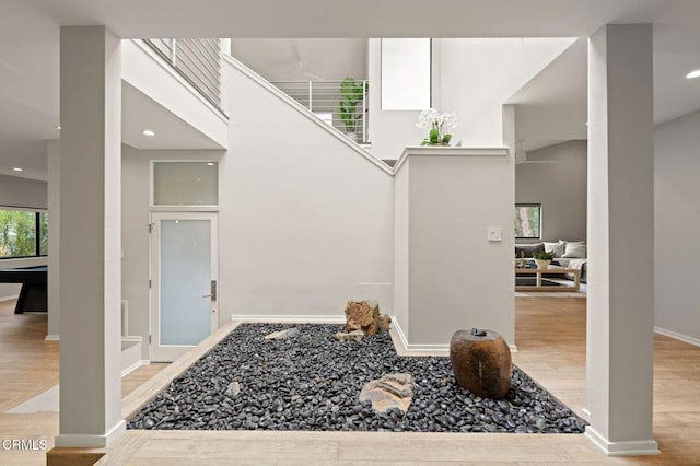 foyer with wood finished floors, baseboards, and recessed lighting