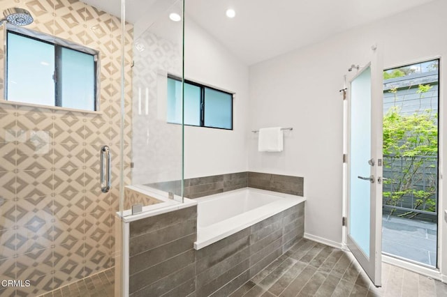 bathroom with a bath, baseboards, recessed lighting, wood finished floors, and tiled shower