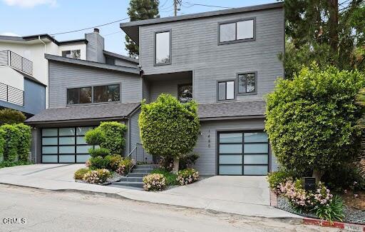 contemporary home featuring an attached garage and driveway