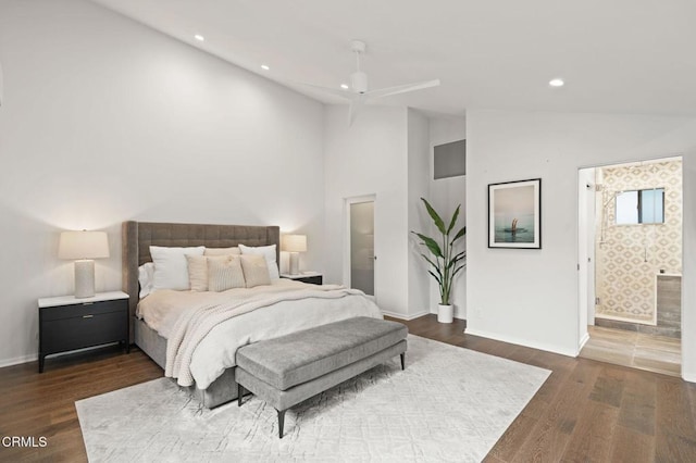 bedroom with ensuite bathroom, baseboards, dark wood-style floors, recessed lighting, and high vaulted ceiling