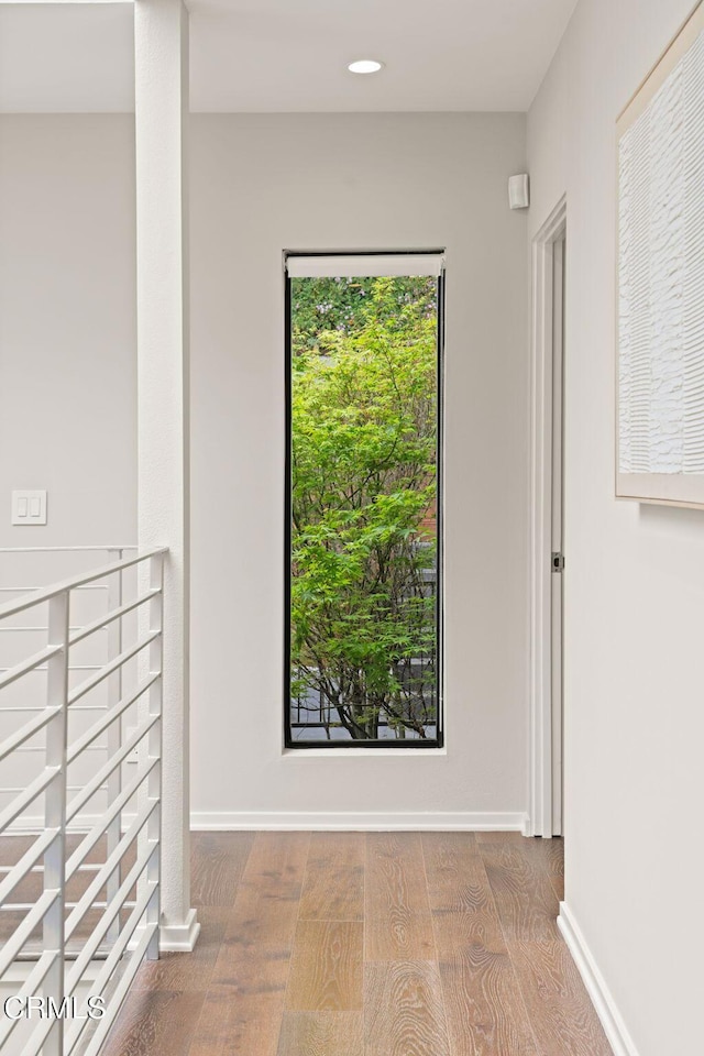 hall with baseboards, recessed lighting, and wood finished floors