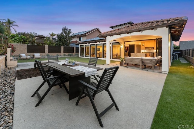view of patio / terrace with outdoor dining area, an outdoor hangout area, and a fenced backyard