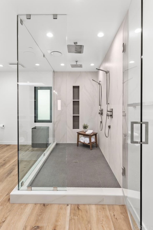 bathroom with a stall shower, recessed lighting, and wood finished floors