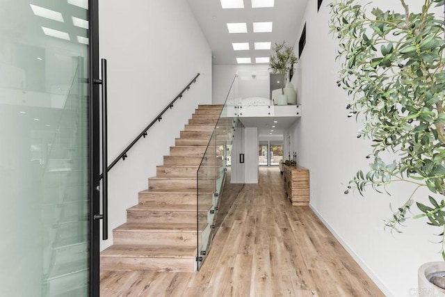 5186 Maynard St, San Diego, CA 92122 - foyer with stairway, high vaulted ceiling, light wood-style floors, and a skylight