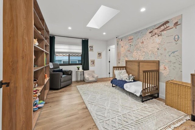 5186 Maynard St, San Diego, CA 92122 - bedroom featuring a skylight, recessed lighting, and light wood-style flooring