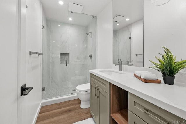 5186 Maynard St, San Diego, CA 92122 - bathroom featuring vanity, a marble finish shower, wood finished floors, and recessed lighting