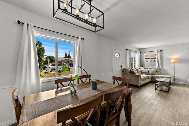11525 Corby Ave, Norwalk, CA 90650 - dining room featuring baseboards, wood finished floors, and a chandelier