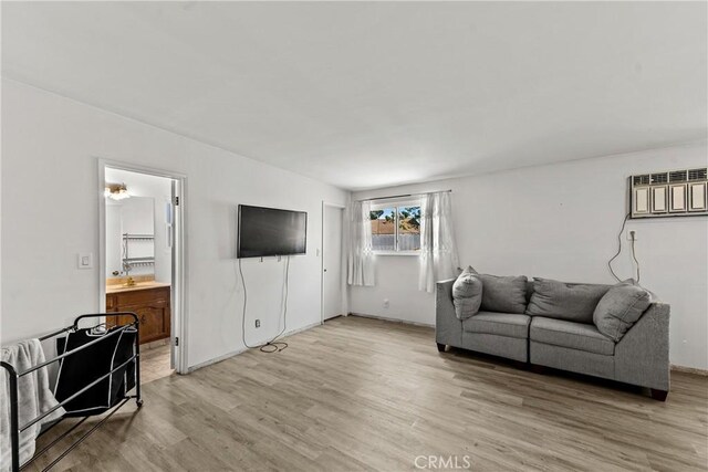 11525 Corby Ave, Norwalk, CA 90650 - living area featuring light wood-type flooring and a wall unit AC
