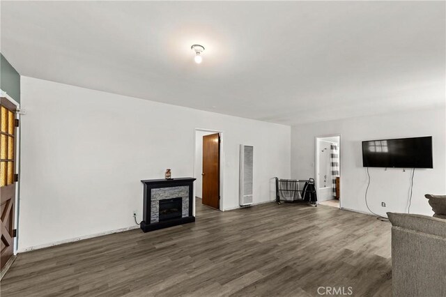 11525 Corby Ave, Norwalk, CA 90650 - unfurnished living room with a heating unit, wood finished floors, and a fireplace
