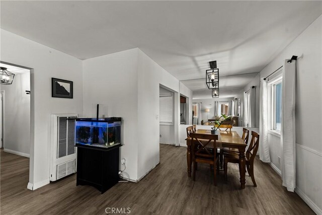11525 Corby Ave, Norwalk, CA 90650 - dining space featuring wood finished floors, a chandelier, and a heating unit