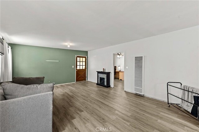 11525 Corby Ave, Norwalk, CA 90650 - living area featuring a heating unit, light wood finished floors, and a fireplace