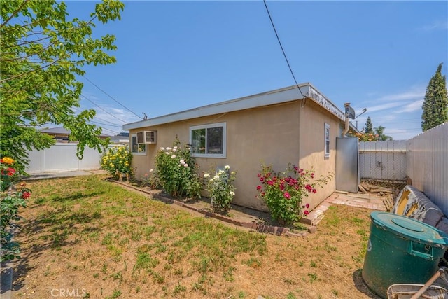 11525 Corby Ave, Norwalk, CA 90650 - view of property exterior with stucco siding and an AC wall unit