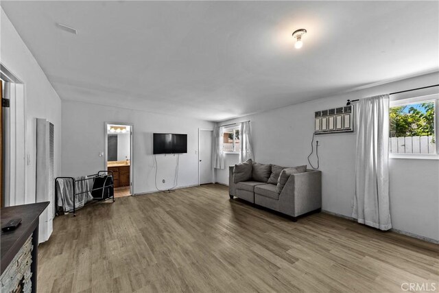 11525 Corby Ave, Norwalk, CA 90650 - living area with light wood-style flooring and an AC wall unit