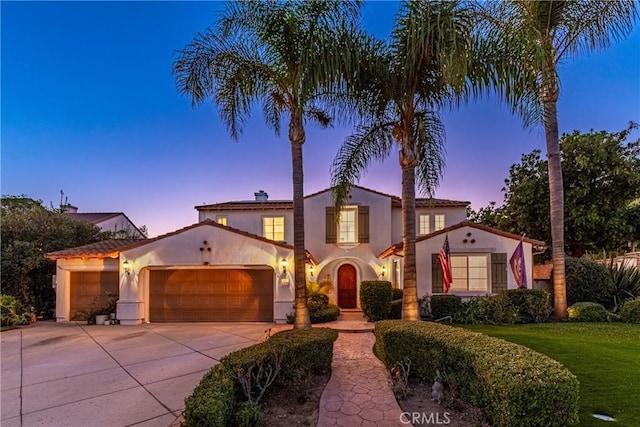 991 Clear Sky Pl, Simi Valley, CA 93065 - mediterranean / spanish-style house with an attached garage, concrete driveway, stucco siding, and a lawn