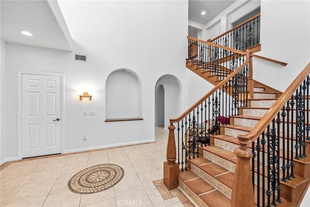 991 Clear Sky Pl, Simi Valley, CA 93065 - stairway with arched walkways, tile patterned floors, a high ceiling, and recessed lighting
