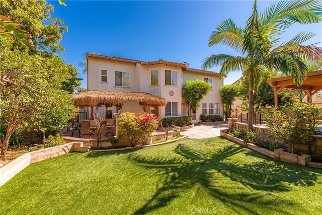 991 Clear Sky Pl, Simi Valley, CA 93065 - rear view of property featuring stucco siding, a yard, and a patio area